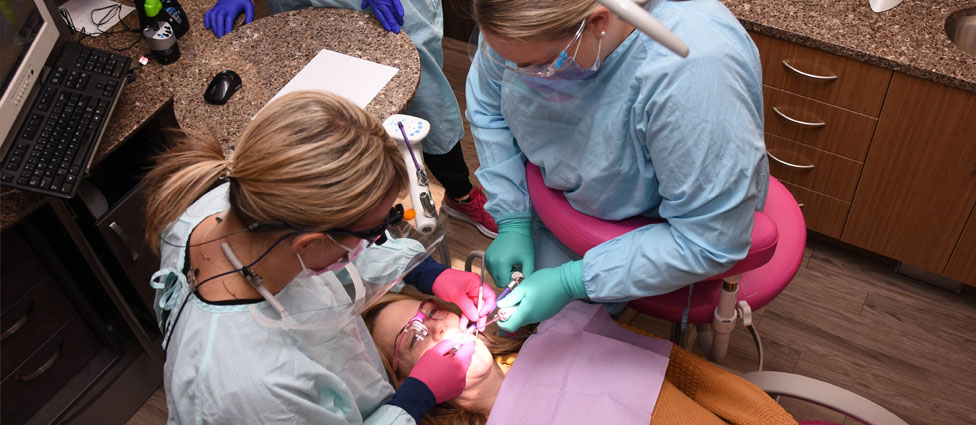 Performing dental hygiene on patient